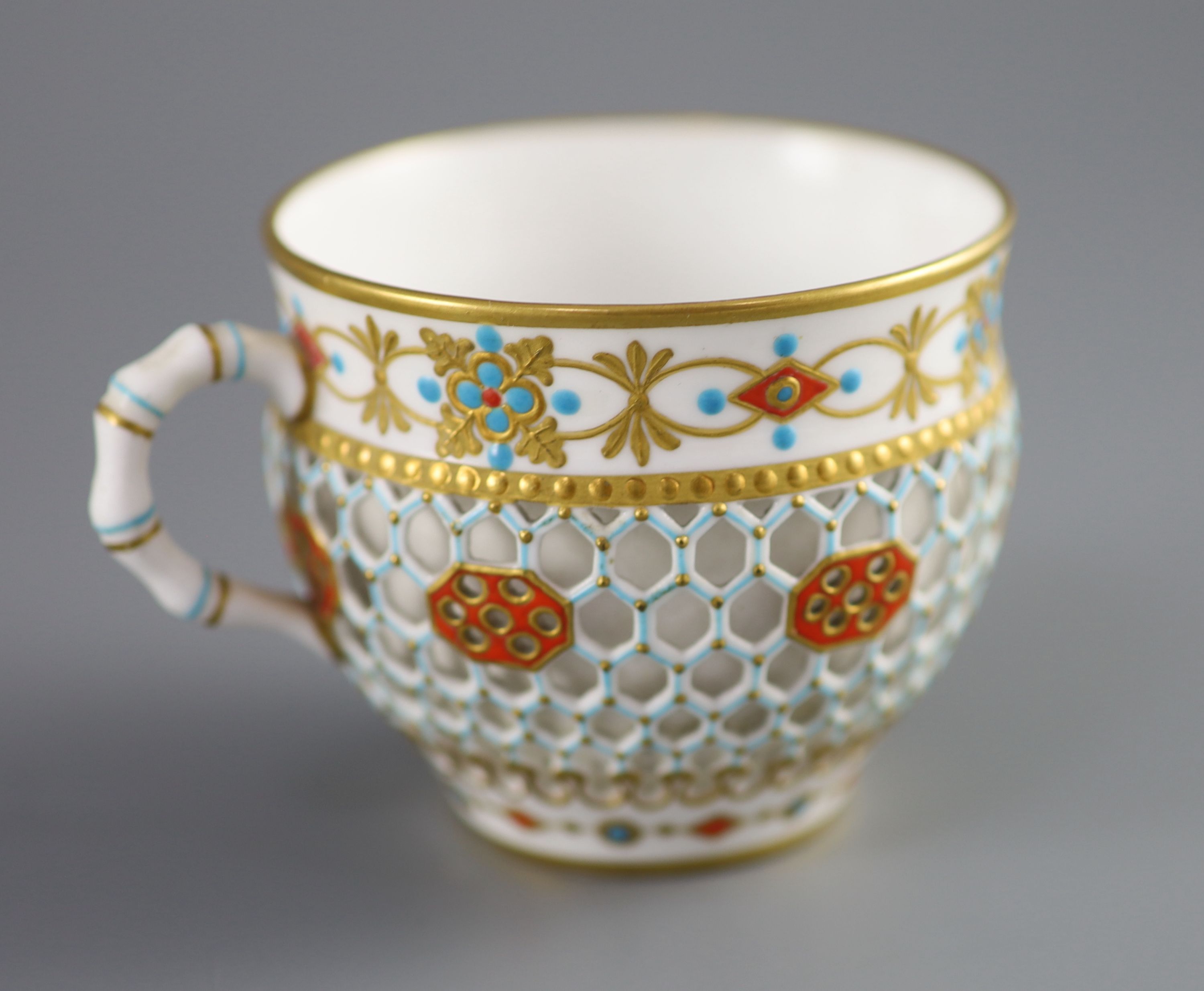 A Royal Worcester 'jewelled' and reticulated cup and saucer